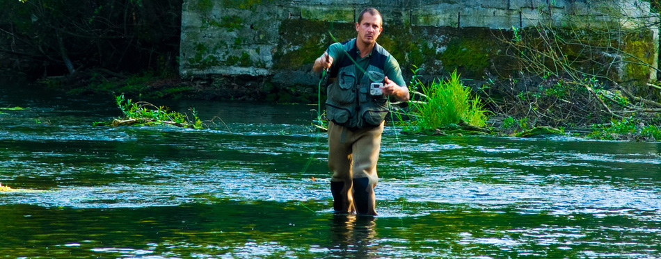 fly fisherman wearing wading boots