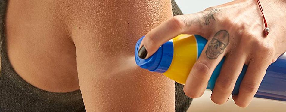 spraying sunscreen